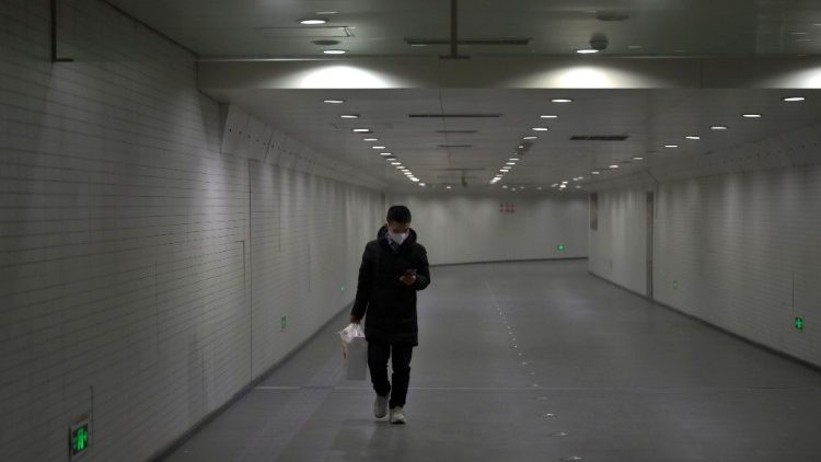 Man wearing a face mask walks in a subway station, following an outbreak of the novel coronavirus, in Beijing