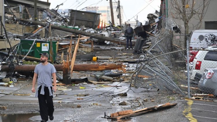 A man looks at the destruction left after a tornado hit eastern Nashville