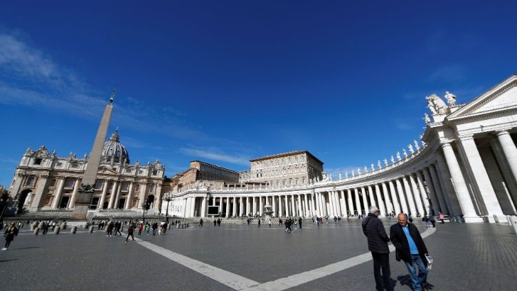 People walk in Saint Peter's Square at the Vatican