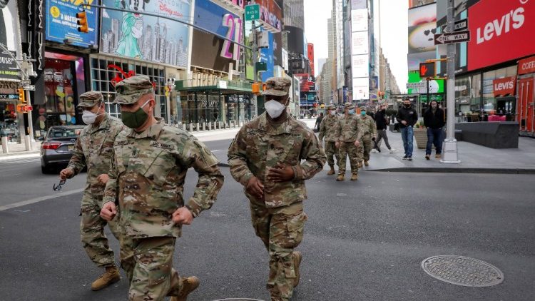 New York State Army National Guard soldiers walk through Times Square, during the outbreak of the coronavirus disease (COVID-19) in New York