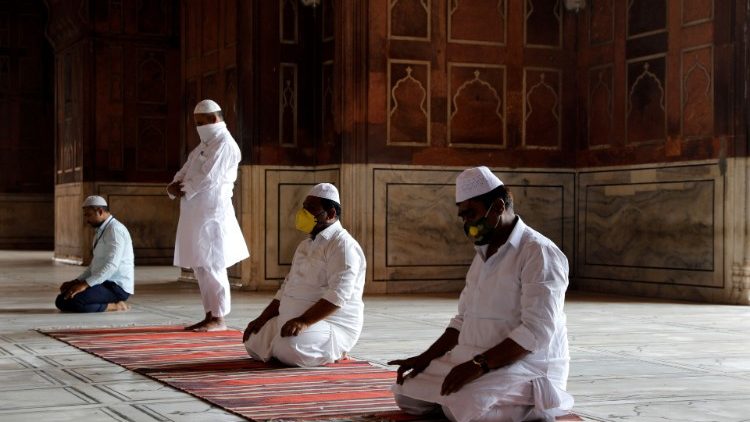 Muslim men wearing masks in prayer in Delhi, India