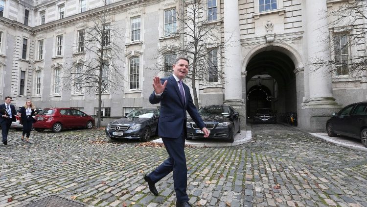 Irish Finance Minister walks outside Government Buildings in Dublin
