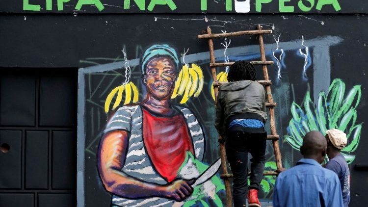FILE PHOTO: An artist works on a mural advocating for retail M-Pesa mobile phone cashless payments as a measure against the spread of the coronavirus disease (COVID-19) in Nairobi