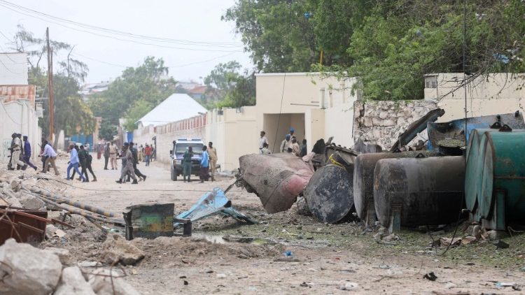A general view shows Somali policemen at the scene after suicide car bomber drove into a checkpoint outside the port in Mogadishu