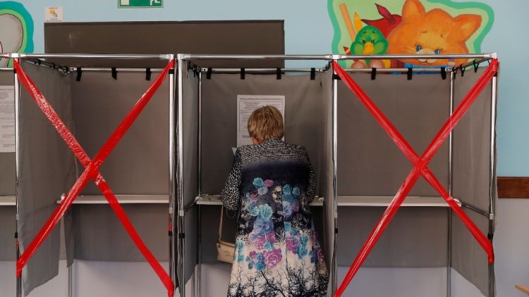 Woman checks her ballot in a voting booth during local elections in the Siberian city of Tomsk
