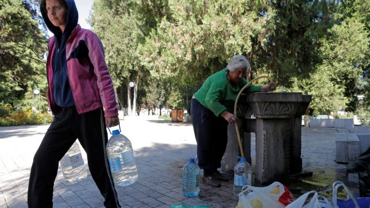 Local residents collect water in Stepanakert
