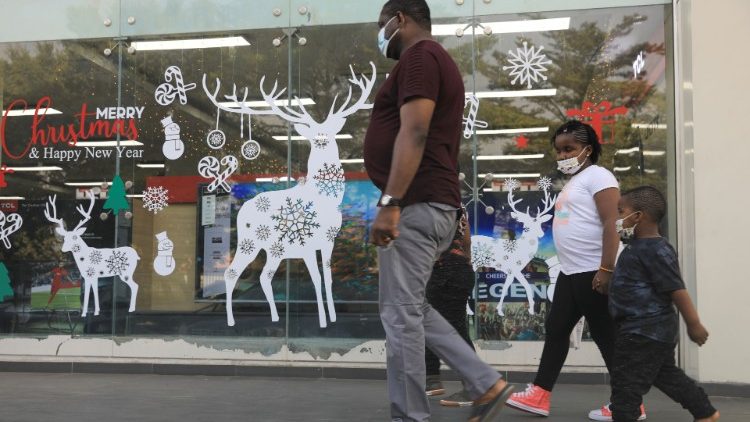 A family walk past Christmas decorations at Cherries Hypermarket on the eve of Christmas during the coronavirus disease (COVID-19) outbreak in Abuja