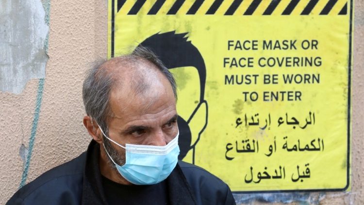A man wearing a protective face mask waits to get tested for the coronavirus disease (COVID-19), in Beirut