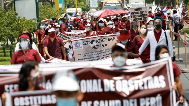 Health workers march while going on an indefinite strike as they demand a better national health budget and access to vaccines, in Lima, Peru