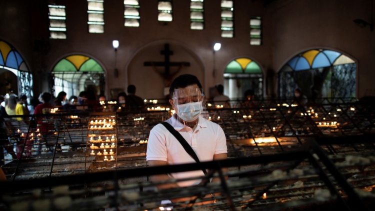Ein Gläubiger im Gebet in einer Kirche in Manila