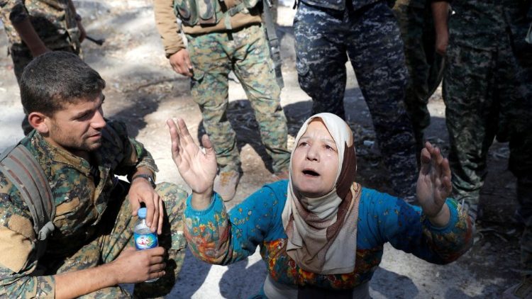 A Syrian woman surrounded by soldiers