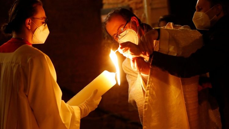 A priest in Germany lights an Easter candle