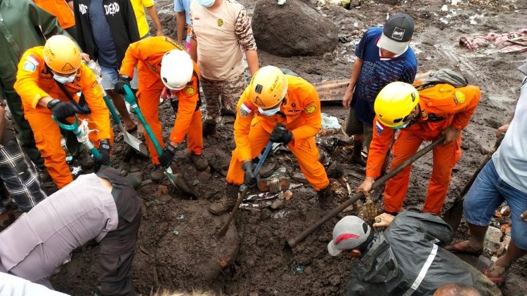 Indonesia rescue agency search for a body at an area affected by flash floods after heavy rains.