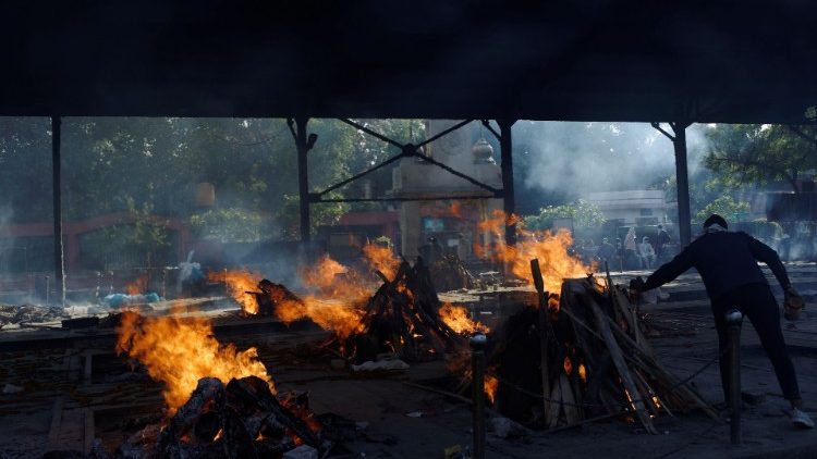 Funeral fires of those who died of Covid-19 at a crematorium in New Delhi, India.  