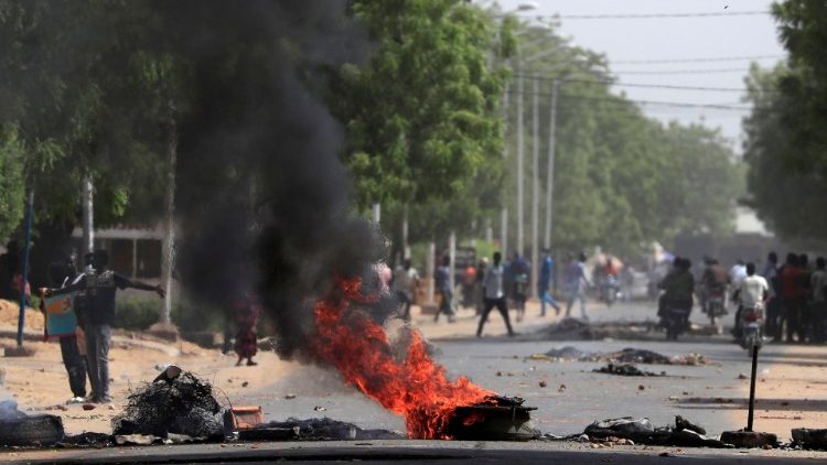 Tires burn at a barricade during protests demanding return to civilian rule in N'Djamena