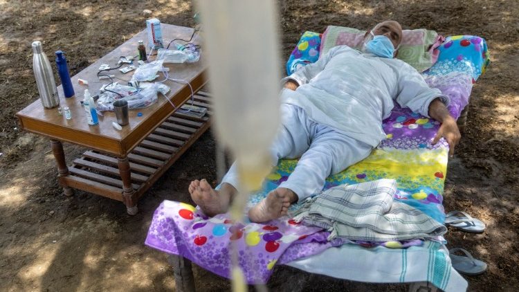 A Covid-19 patient receives treatment at a makeshift open-air clinic in Mewla village, UP, India. 
