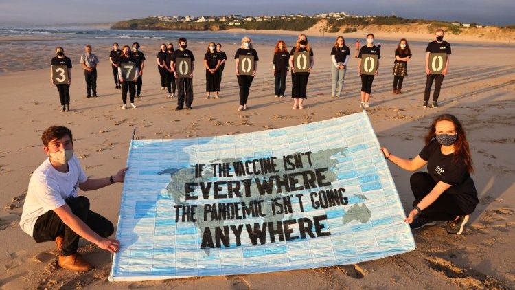 Activists from Crack the Crisis hold a vigil for the people around the world who have passed away due to the coronavirus disease (COVID-19) on the sidelines of G7 summit, at Porthkidney beach near Carbis Bay