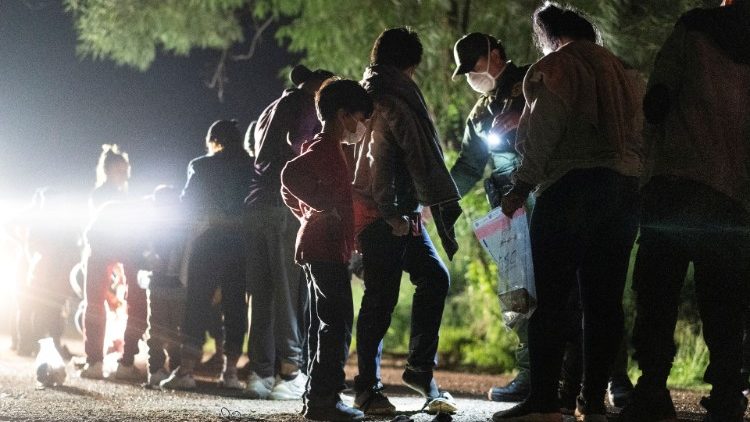 Asylum-seeking migrants cross the Rio Grande river between Mexico and the US