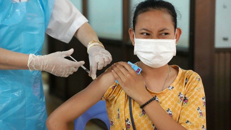 A Cambodian teenager receives a Covid-19 vaccine shot.