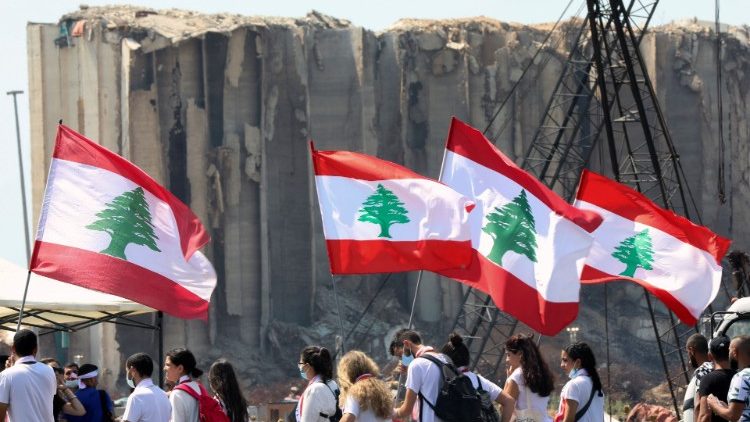 Libaneses com bandeiras em Beirute recordam explosão no porto 