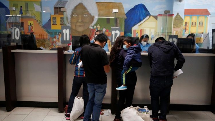 Migrant families register at a migration facility in Guatemala after being deported from the U.S. under title 42