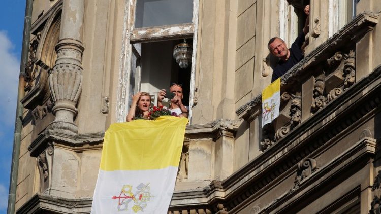 People hang the Vatican flag from their windows in Bratislava