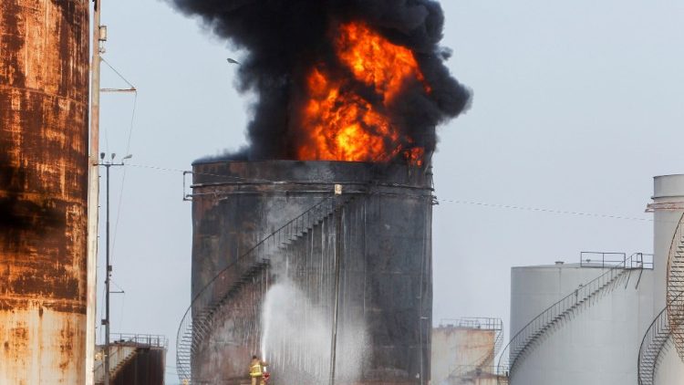 Firefighters attempt to put out a fire at the Zahrani oil facility in southern Lebanon