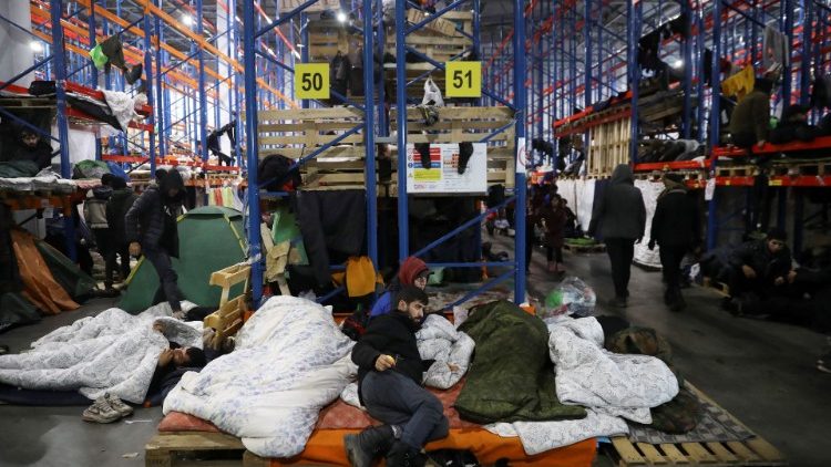 Migrants rest at the transport and logistics centre Bruzgi on the Belarusian-Polish border