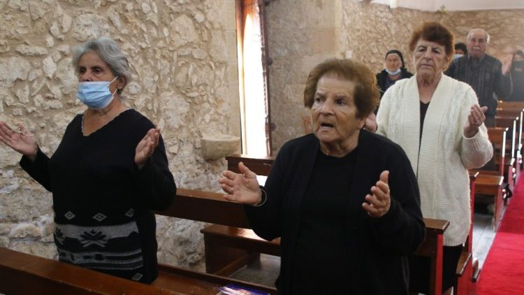 Faithful members sing during a liturgy at the Church of St. George in Kormakitis, Cyprus.