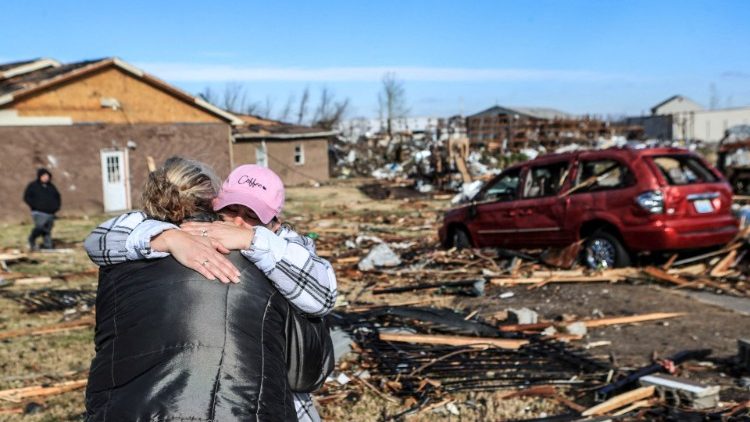 Survivors console one another outside a women and children's shelter in Mayfield, Kentucky, that was destroyed by a tornado