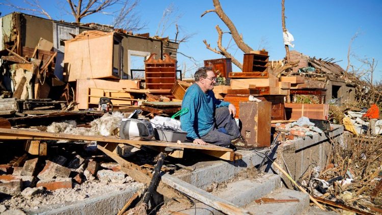 A man sits amid the ruins of his home in Mayfield, Kentucky