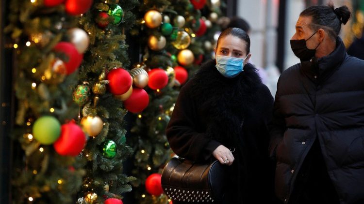 Menschen gehen an einem weihnachtlich geschmückten Geschäft in der New Bond Street in London vorbei
