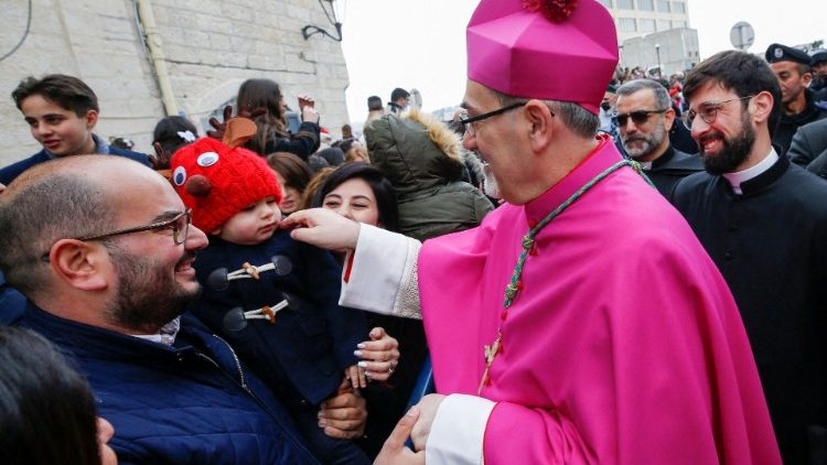 Patriarch Pizzaballa greets the faithful during Christmas celebrations at the Church of the Nativity in Bethlehem