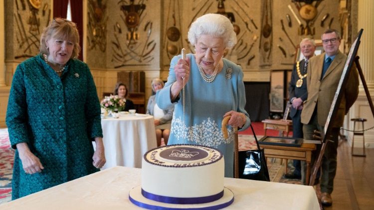 Queen Elizabeth cuts a cake to celebrate the Platinum Jubilee