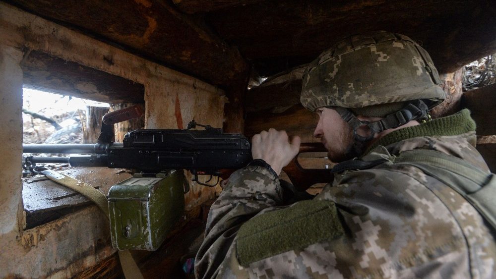 Ukrainian service members guard the area near the line of separation in the Donetsk region