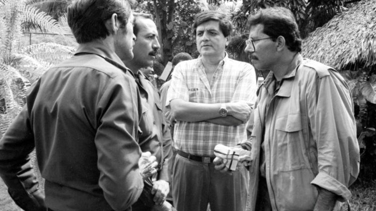 Colonel Hugo Torres talks with his revolutionary comrade President Daniel Ortega and other colleagues during a meeting of the Sandinista Popular Army in Managua in 1988