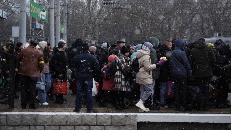 Civilians line up to board a train in Odessa as they flee Russia's invasion of Ukraine