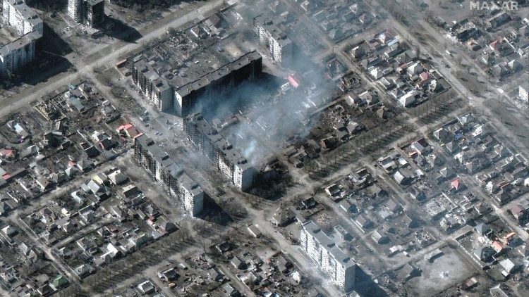A satellite image shows burning and destroyed apartment buildings, in Mariupol, Ukraine