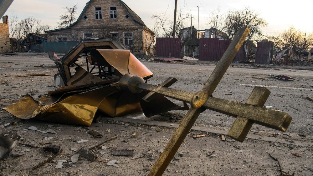 A cross and a dome of a local church damaged by shelling are seen in the settlement of Hostomel
