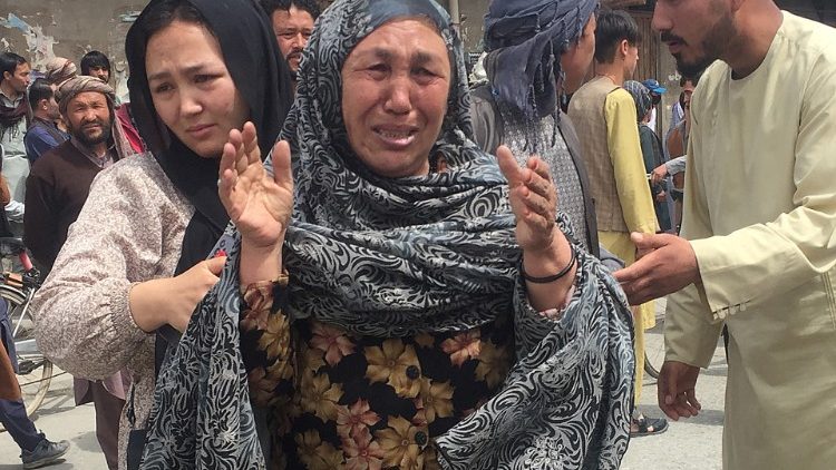 An Afghan woman cries after blasts at a school in Kabul, Afghanistan, 19 April 2022. 