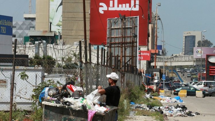 A man searching food in bins in Beirut