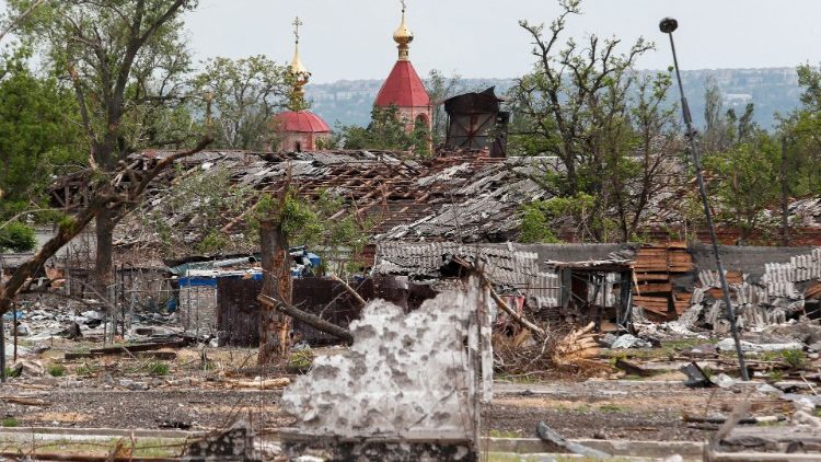 A view of a church behind destroyed buildings in the Luhansk region in eastern Ukraine