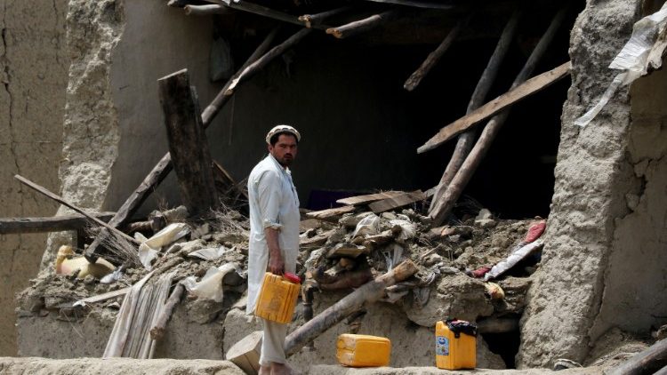 A man looks on in front of a damaged property after a recent earthquake in Gayan
