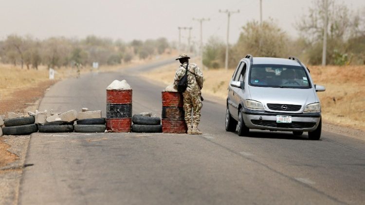 A soldier checks a vehicle at a military check point in Dapchi, Yobe state