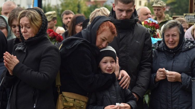 Mourners attend the funeral of a Ukrainian servicemen