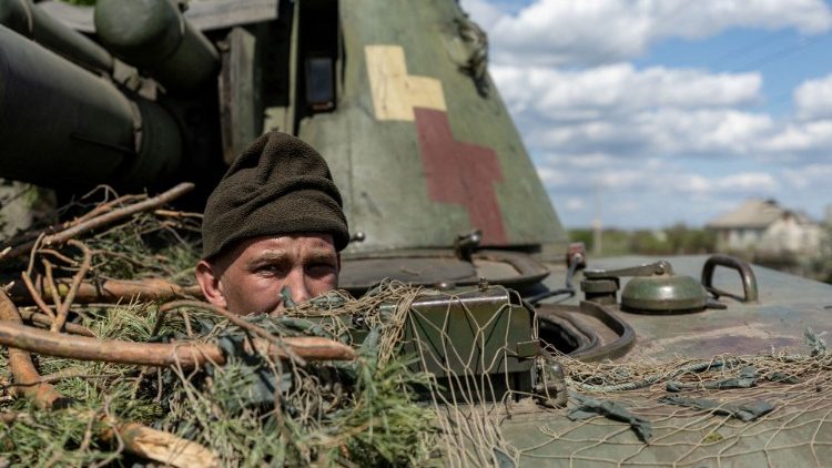 File photo: A Ukrainian soldier looks out from a tank in the city of Lyman
