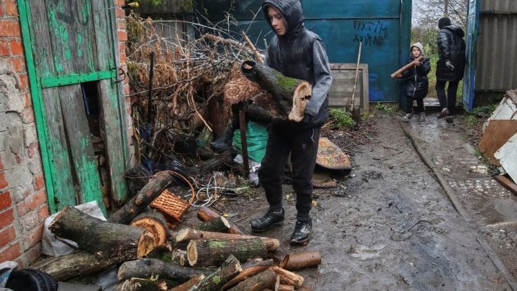 Moradores locais carregam lenha entregue pela administração local para aquecer suas casas, enquanto o ataque da Rússia à Ucrânia continua, na vila de Derhachi, região de Kharkiv, Ucrânia 20 de outubro de 2022. REUTERS/Vyacheslav Madiyevskyy
