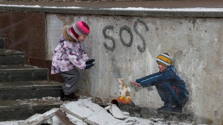 Anastasia, 4, ao lado de uma obra de arte do famoso artista de rua Tvboy no centro da cidade, em meio ao ataque da Rússia à Ucrânia, em Bucha, nos arredores de Kyiv, Ucrânia, 29 de janeiro de 2023. REUTERS/Valentyn Ogirenko