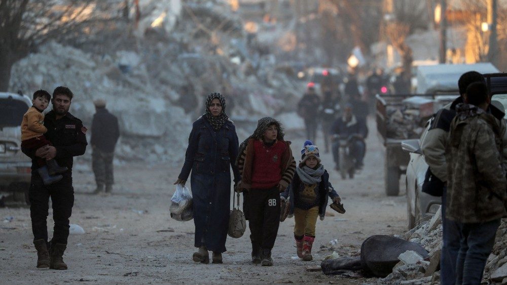 Pessoas passam por prdios danificados aps um terremoto na cidade de Jandaris, controlada pelos rebeldes, na , em 9 de fevereiro de 2023 REUTERS/Khalil Ashawi