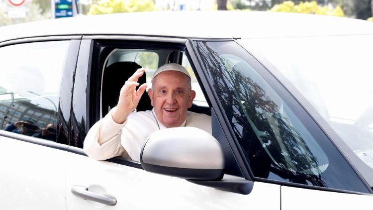 Pope Francis waves from a car as he leaves Rome's Gemelli hospital in Rome